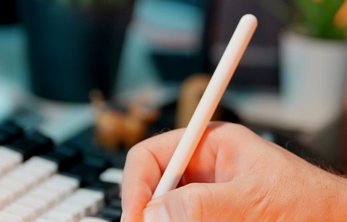 Someone is using a stylus on a tablet.